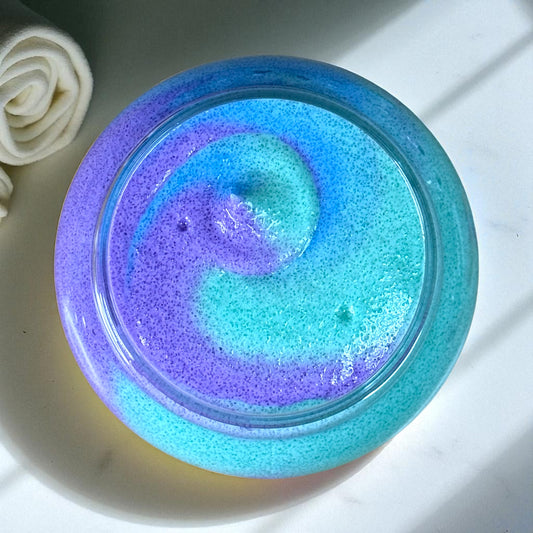 Purple and blue Crunch Berry Swirl whipped sugar scrub in clear plastic jar.