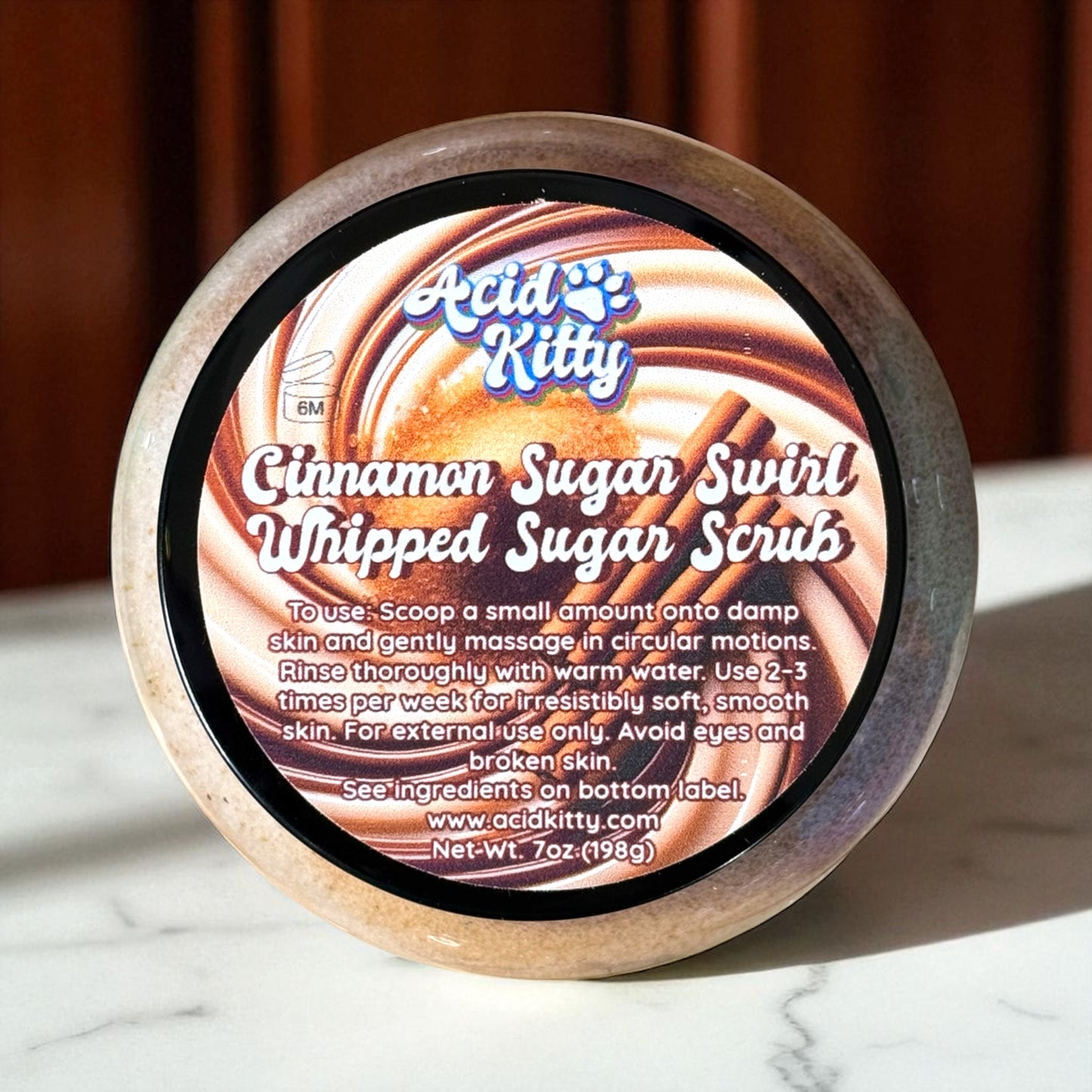 Acid Kitty Cinnamon Sugar Swirl Whipped Sugar Scrub container on a marble surface