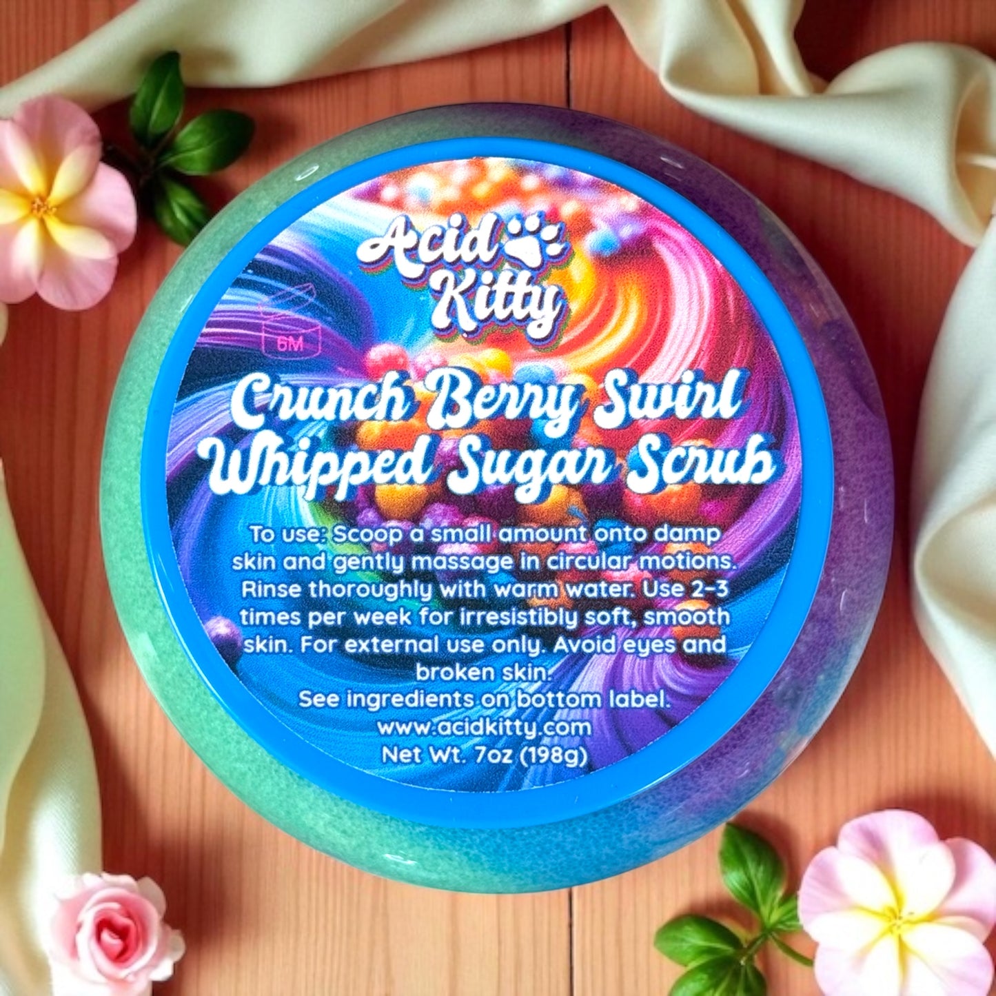 Container of Acid Kitty Crunch Berry Swirl Whipped Sugar Scrub with colorful label on a wooden surface.