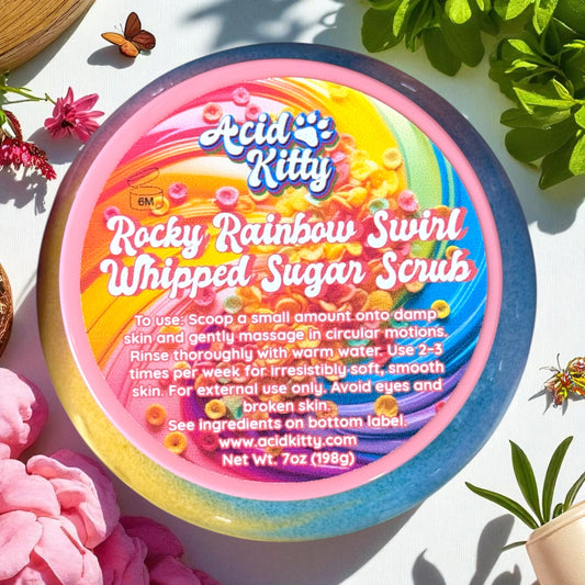Acid Kitty Rocky Rainbow Swirl Whipped Sugar Scrub container with colorful design on a white background with flowers and plants.