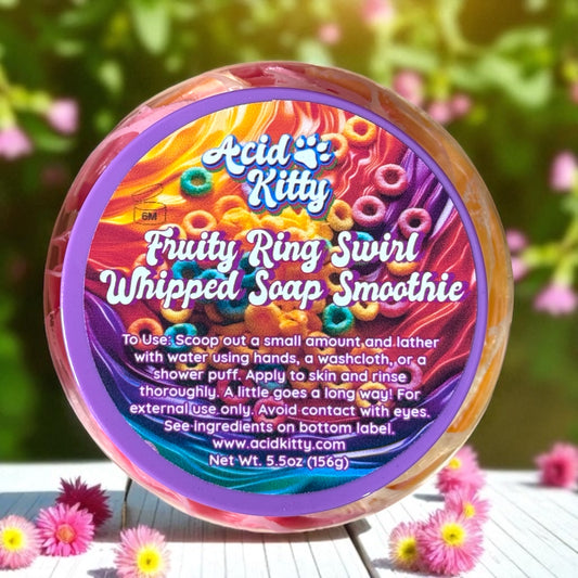 Colorful container of 'Acid Kitty' Fruity Ring Swirl Whipped Soap Smoothie with a floral background.