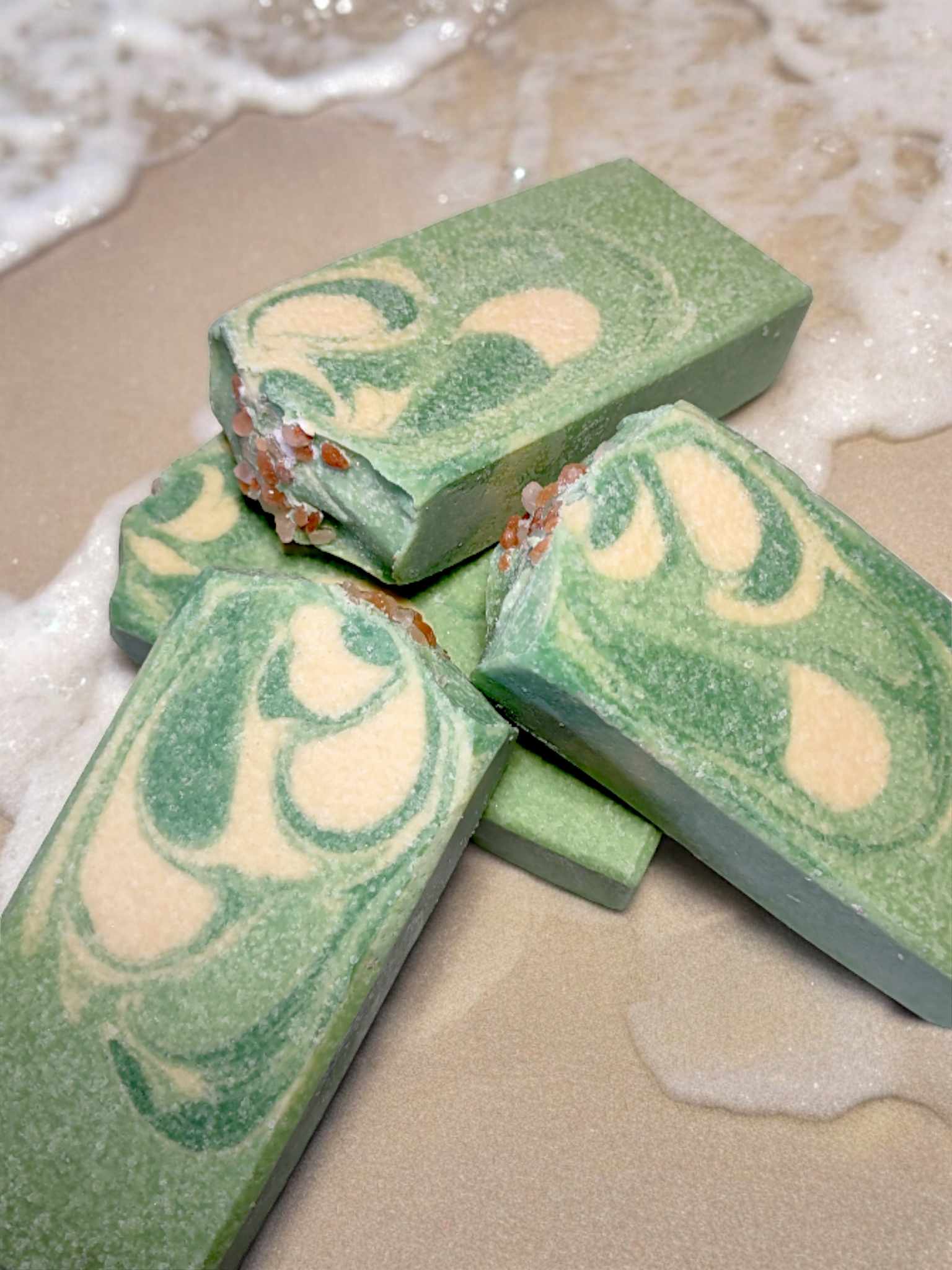 A bar of handmade Mojito Artisan Salt Bar with a green and yellow swirled pattern on a light background, resembling a mojito cocktail.