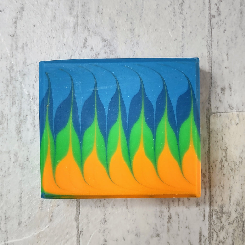 An orange, green, and blue bar of soap in a swirl pattern. 