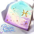 A bar of soap with purple and lavender swirls, featuring gold stars and the Pisces symbol, with the text 'Pisces Nation' displayed.