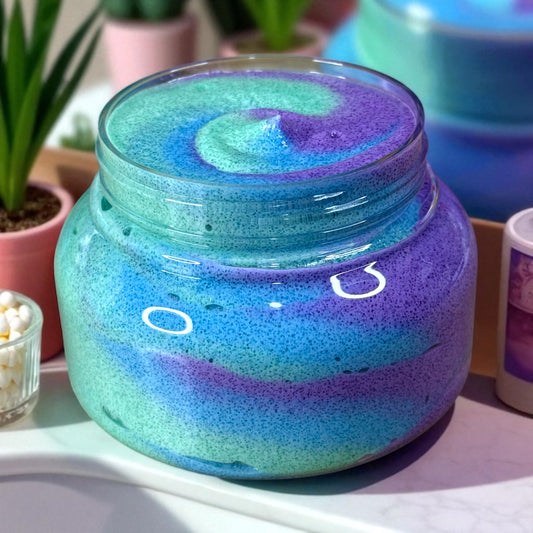 Purple and blue Crunch Berry Swirl whipped sugar scrub in clear plastic jar.